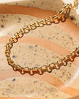 14k gold fill Roen anklet on a orange plate