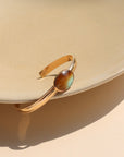 A 14k gold fill smooth cuff with a 13x18mm turquoise stone set at its center