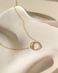 14k gold fill spiral necklace by token jewelry, photographed on a white dish