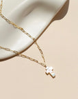 14k gold fill paperclip chain with a mother of pearl pendant in the sunlight