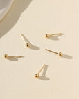 gold fill classic studs laid in the sun