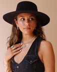 925 sterling silver chain earrings photographed on a brunette model wearing a black cowboy hat