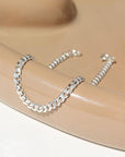 925 sterling silver cuban style chain link bracelet, laid out on a curvy ceramic dish Edit alt text