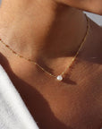 14k gold fill Beaded pearl necklace photographed on a model wearing a white sweater