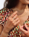 Model wearing a coral gemstone ring set in a 14k gold fill bezel
