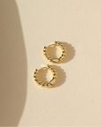 14k gold fill textured chunky hoops on a light background