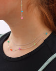 Model wearing sterling silver necklace featuring six vibrant opals and a textured chain with bar, dot, and dash links.