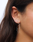 Model wearing a sterling silver hoop with wave-like textured wire