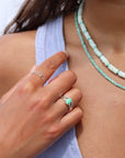 Model wearing two sterling silver rings with wave-like textured wire, model paired it with a amazonite gemstone ring set in sterling silver