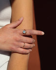 model wearing 14k gold fill ring with 8mm aquamarine stone paired with other simple 14k gold fill rings