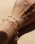 model wearing 14k gold fill gemlink bracelet with emerald