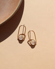A post earring with 14k gold fill wire earring with a 8mm moonstone gemstone. The earrings are displayed on a cream back drop.