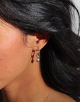 model wearing sterling silver heart charm on sterling silver classic hoops