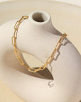 Gold filled piper anklet draped over stone dish