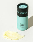 Lip balm container labeled 'Basil Mint' on a light background
