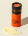 Lip balm container labeled 'Blood Orange & Grapefruit' on a beige background