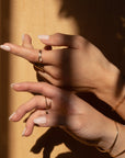 Hands with 4mm moonstone ring on in the shadows.