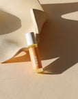 peach colored perfume roller near a dish in the sunlight - scent Joshua Tree