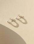 sterling silver small curb chain stud earrings on a light background