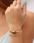 Model wearing a 14k gold fill smooth cuff with a 13x18mm turquoise stone set at its center