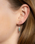 Model wearing 14k gold fill arch earrings with gemstone beads
