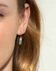Model wearing 14k gold fill arch earrings with gemstone beads