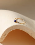 14k gold fill bezel ring with a 4mm lapis lazuli stone in the sunlight