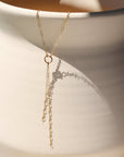 Gold lariat necklace with circle pendant and double chain drop