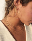 Makara Chain by Token Jewelry in 14k gold fill, photographed on a model wearing a white vest top and other 14k gold fill jewelry