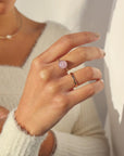 Model wearing our gold Pippa ring. This ring features a Pink Kunzite gemstone with a delicate spiral band.