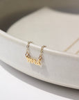 14k gold fill Mrs.Necklace laid on a white jewelry dish in the sunlight. This is perfect to gift any bride to be in your life.
