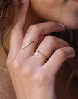 Model wearing 14k gold fill Heart Charmed Ring on ring finger