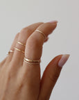 14k gold fill Minimal Midi Ring on models finger. This Ring features a simple band that is smooth perfect for everyday wear.