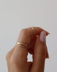 14k gold fill Minimal Midi Ring on models finger. This Ring features a simple band that is smooth perfect for everyday wear.