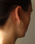 Model wearing 14k gold fill goldie hoops.