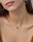 Model wearing spear-shaped labradorite pendant on gold chain, handmade anniversary jewelry