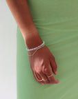 Model wearing a 14k gold fill bracelet with a mixture of Turquoise, Kunzite, Chrysophrase, Serpentine, and Calcedony Gemstones.