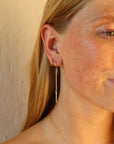 model wearing 14k gold fill dangle earrings