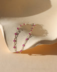 sterling silver chain with transparent ruby gemstones on a dish