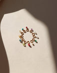 circle of tiny birthstone gemstones on jump rings in the sunlight