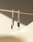 sterling silver stud earrings with chain and tourmaline beads in the sunlight