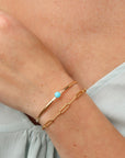 Model wearing Turquoise Skyline Cuff featuring a 6mm Sleeping Beauty turquoise cabochon on a hand-notched gold filled band.