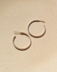 petite maeve hoops in 14k gold fill by token jewelry, a medium-sized hoop with a post, featuring a textured edge