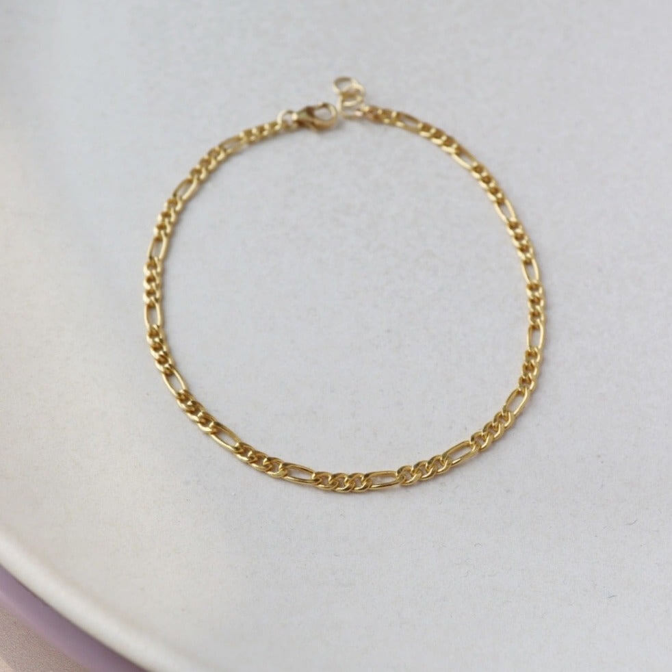 14k gold fill Gigi Anklet placed on a white plate. - Token Jewelry