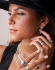 925 sterling silver chain earrings photographed on a brunette model wearing a black cowboy hat