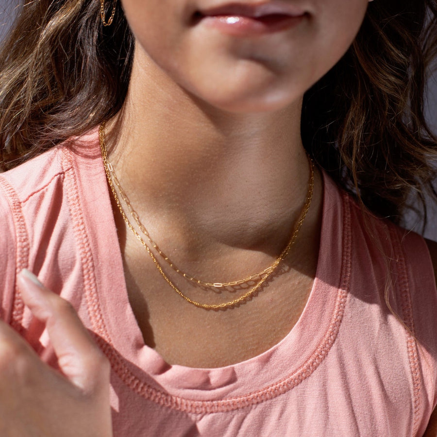 Model found wearing 14k gold fill Gemma Chain  paired with the narrow link chain.