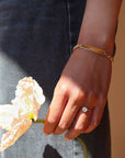 Model wearing 14k gold fill Name plate bracelet with Alexandra chain. This bracelet features a simple plate you can choose to have hammered or have smooth. This bracelet is then connected with the Alexandra chain. With this bracelet it features the option of adding a name or not.