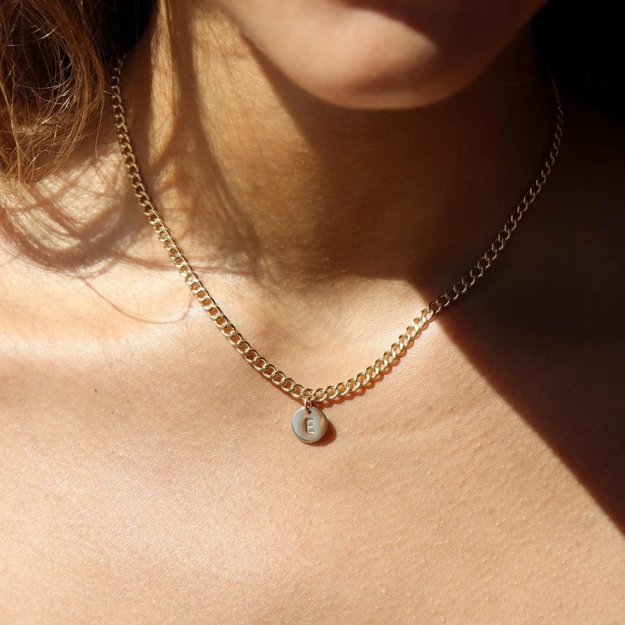 Model wearing 14k gold fill Modern Muse initial necklace.This Necklace feature our Demi Alexandra chain featuring a charm initial of your choice.