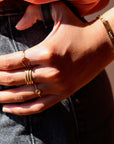 Model Wearing 14k gold fill Gaia Ring. This ring features a Spiral band with a zircon gemstone.