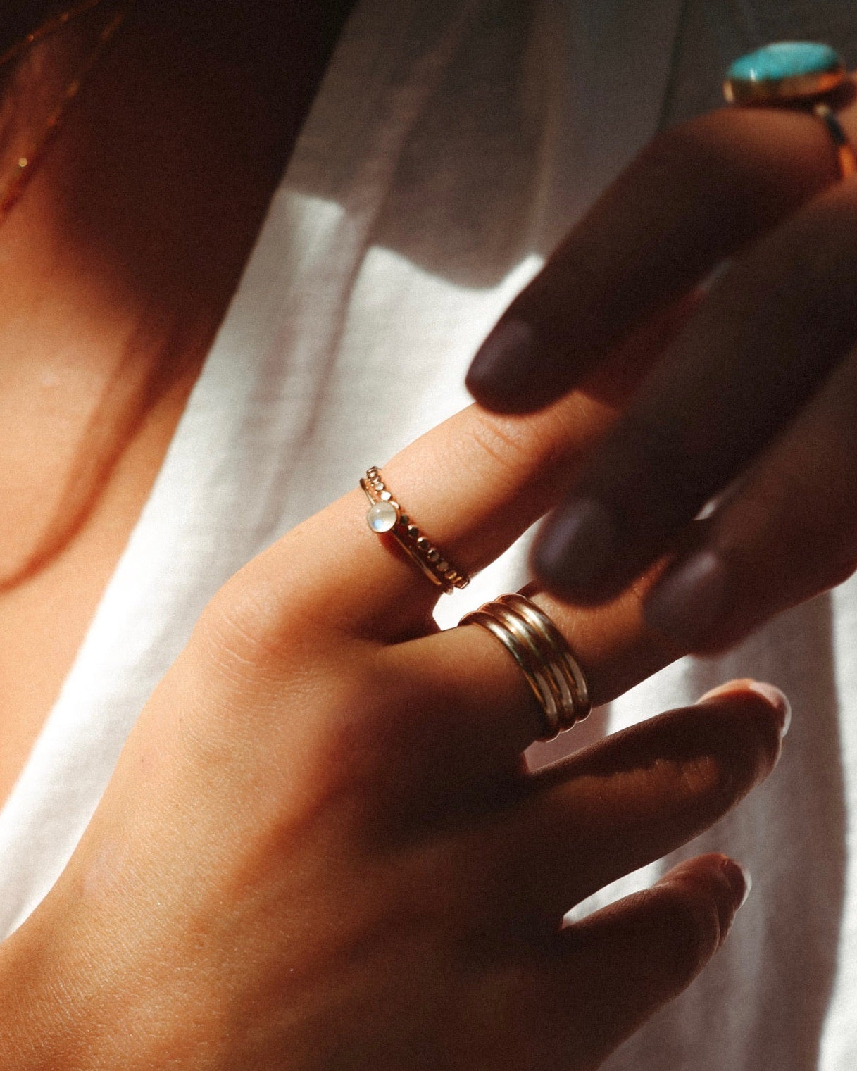 Model wearing 14k gold fill rings with a 4mm moonstone gemstone ring on a sleek minimal band. 